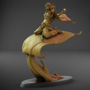May include: A detailed sculpture of a fantasy figure riding a magic carpet. The figure is a woman wearing ornate clothing and a crown, holding a staff. The carpet has detailed patterns and is supported by a flowing, stylized base. The sculpture is in a warm, golden color.