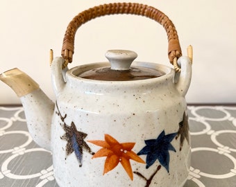 Vintage Stoneware Teapot with Leaf Detail and Wrapped Wicker Handle