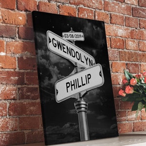 May include: Black and white canvas print of a street sign with the names Gwendolyn and Phillip on it. The date 03/08/2019 is also on the sign. The sign is against a black background with white clouds and stars.