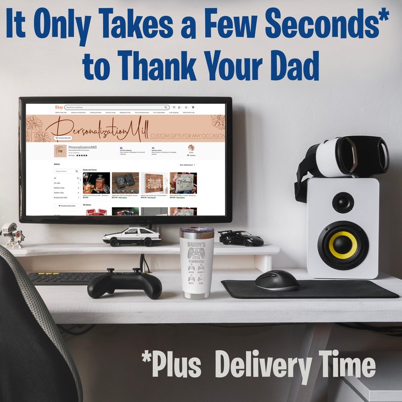 May include: A white and gray stainless steel tumbler with a black and white graphic of a video game controller and the text "Daddy's Got Game". The tumbler is on a desk with a computer monitor, a video game controller, and a mouse.