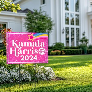 May include: Pink and white yard sign with glitter and a rainbow design. The sign reads "Kamala Harris and Tim! 2024".