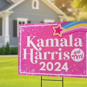 May include: Pink and white yard sign with glitter and a rainbow design. The sign reads "Kamala Harris 2024" and has a small circle with the text "and Tim!"