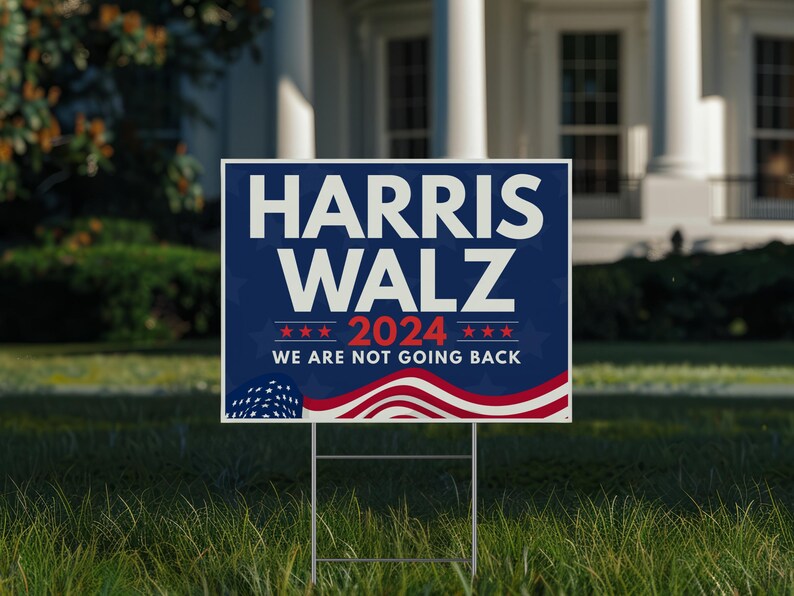 May include: A blue and red political campaign sign with the text "Harris Walz 2024 We Are Not Going Back" and stars and stripes design.