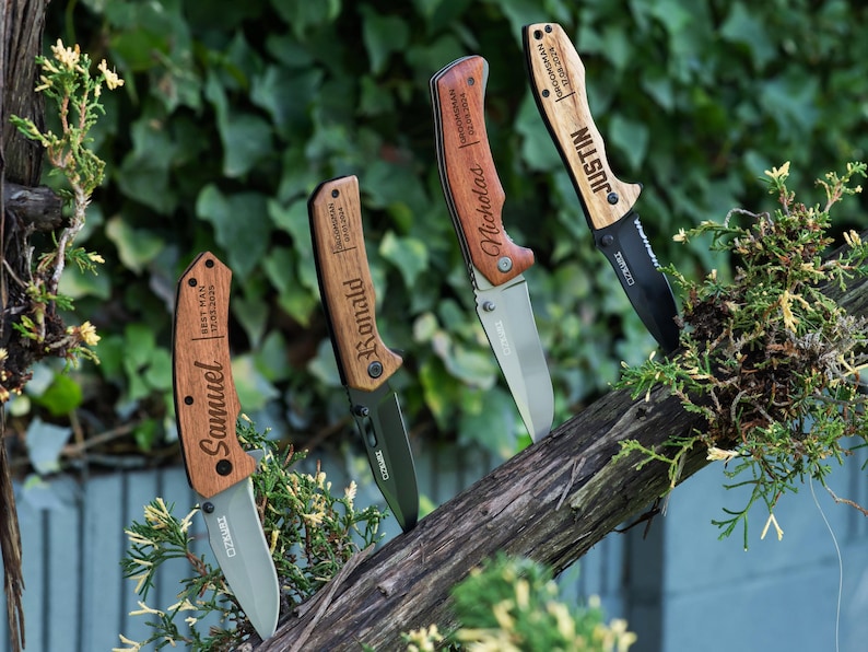May include: Four personalized pocket knives with wooden handles. The handles are engraved with the names "Samuel", "Ronald", "Nicholas", and "Justin".