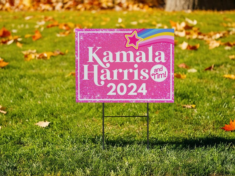 May include: Pink and white yard sign with glitter and a rainbow design. The sign reads "Kamala Harris and Tim! 2024".