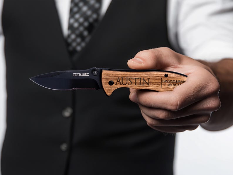 May include: A black pocket knife with a wooden handle. The handle is engraved with the name "Austin" and the text "Groomsman 21.01.2023".