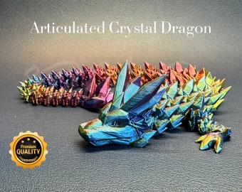 May include: A multi-colored iridescent crystal dragon figurine with articulated joints. The dragon is posed with its head turned to the side and its tail curled up. The dragon is made of a shiny, reflective material that catches the light.