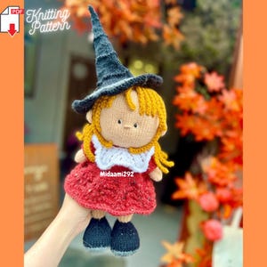 May include: A handmade knitted doll dressed as a witch, featuring a black hat, red dress, and yellow hair. The doll has a white collar and black shoes. The image includes the text "Knitting Pattern" and the seller's name, "Midaami292".