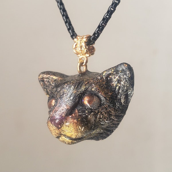 Orgonite cat head pendant with copper bead eyes, copper shavings and shungite powder. Amulet, radiation protection, 5g