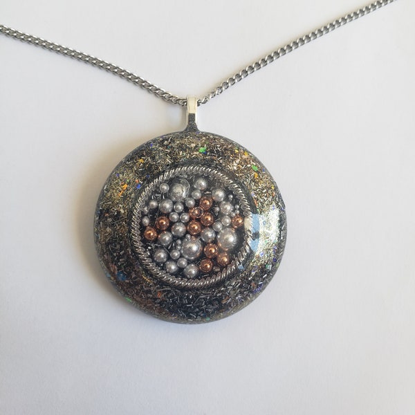 Orgonite pendant with tensor ring and aluminum and copper balls. Amulet and radiation protection