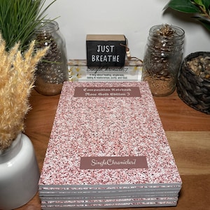 May include: A pink glitter composition notebook with the title "Composition Notebook Rose Gold Edition I" and the text "Single Chronicles 7" on the cover.