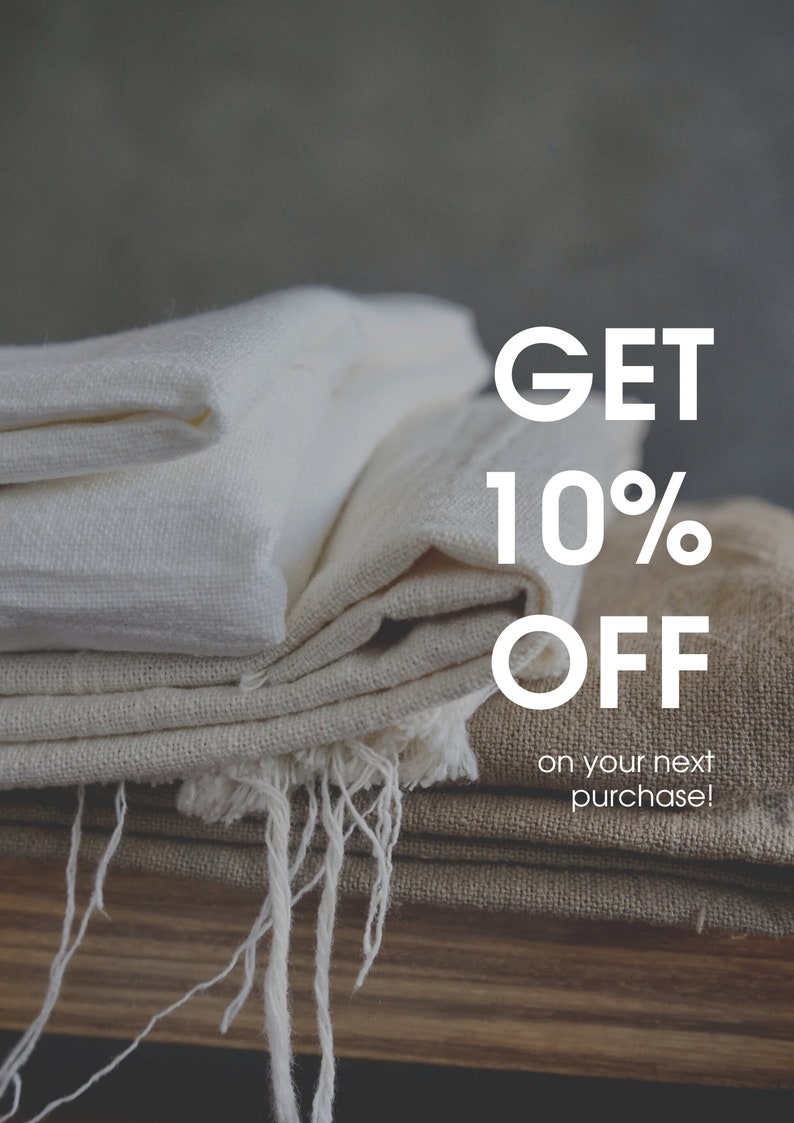 Puede incluir: Una pila de tela blanca y beige doblada con el texto "GET 10% OFF on your next purchase!" en letras blancas.