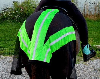 May include: A black fly sheet with a bright green reflective strip down the center. The sheet is designed to protect a horse from flies and other insects.