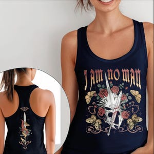 May include: Navy blue tank top with the text "I AM NO MAN" in gold lettering. The design includes a white helmet, red roses, butterflies, and a sword. The back of the tank top has a similar design.