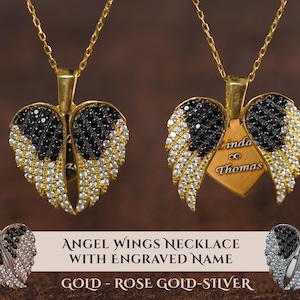 two angel wing necklaces with engraved names on them. The necklaces are made of gold, rose gold, and silver materials, and they are adorned with black and white gemstones. The necklaces are displayed against a brown background, and there is a text overlay that reads "ANGEL WING NECKLACE WITH ENGRAVED NAME GOLD - ROSE GOLD - SILVER".