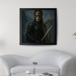 May include: Framed artwork featuring a figure in dark armor, a gold crown, and a mask, holding a sword and a harp. The artwork has a dark, dramatic background and is displayed in a black frame. The image is hanging above a white sofa.