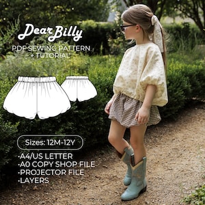 May include: A PDF sewing pattern and tutorial titled Dear Billy for shorts, featuring sizes 12M-12Y, A4/US letter, A0 copy shop file, projector file, and layers. The image shows a child wearing a cream floral top and brown gingham shorts.