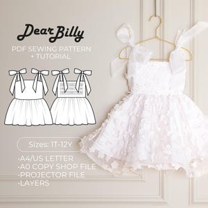 May include: A white dress with floral detailing hangs on a gold hanger. The dress has tie straps and a full skirt. The image also shows a line drawing of the dress and text that reads "Dear Billy PDF Sewing Pattern + Tutorial" and "Sizes: 1T-12Y".