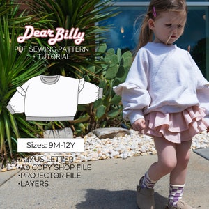 Op de afbeelding: Een wit PDF-naai-patroon voor een geruit sweatshirt voor maten 9 maanden tot 12 jaar. Het patroon bevat instructies voor A4/US Letter, A0 copy shop, projector en gelaagde bestanden.