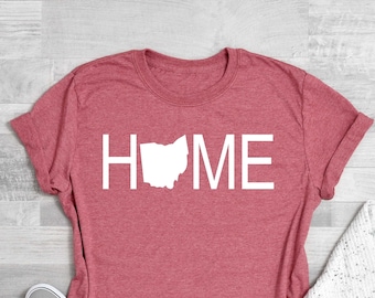 May include: Coral pink t-shirt with a white outline of the state of Ohio and the word "HOME" printed on the front.