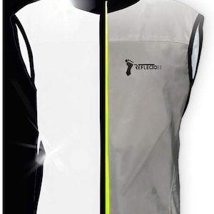 May include: A reflective vest with a black collar and trim, a neon yellow zipper, and the text "REFLECTOES" with a footprint logo. The vest is primarily white and gray, designed for visibility.