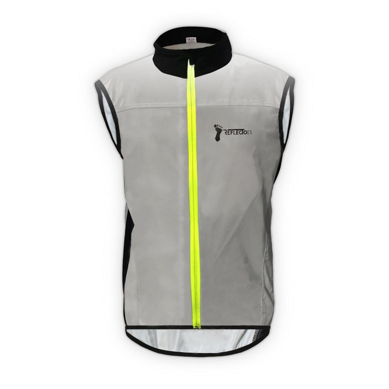 May include: A reflective gray vest with a black collar and trim, featuring a bright yellow zipper. The vest has the text "REFLECTIOES" and a foot logo on the front. Designed for visibility, it is sleeveless and suitable for outdoor activities.