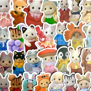 May include: A selection of miniature animal figurines, such as bears and rabbits, dressed in outfits. The figurines are in various colours and styles, some wearing hats and dresses. A charming collection.