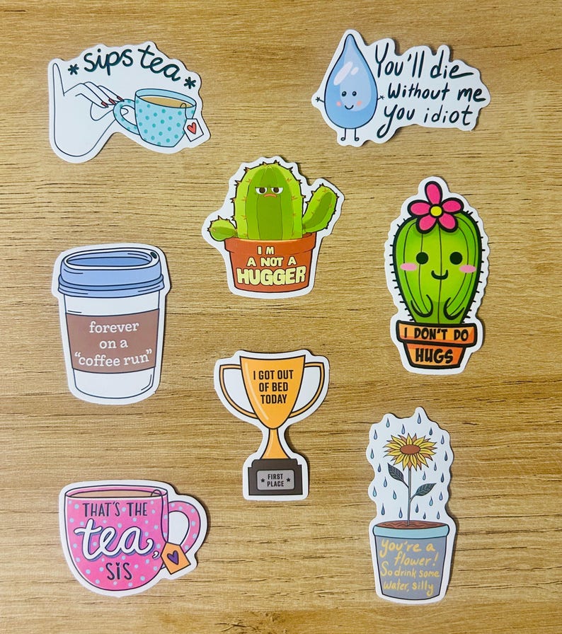 May include: A collection of colorful stickers with various designs and text. The stickers include a hand holding a teacup, a coffee cup, a cactus, a water droplet, a trophy, a teacup, and a sunflower in a pot. The text includes phrases like "sips tea" and "I got out of bed today."