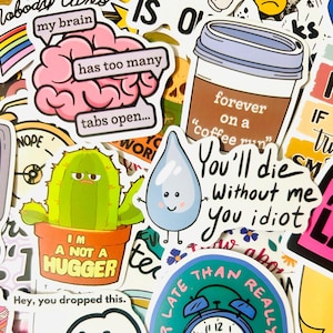May include: A collection of colorful stickers with various designs and text. Includes a pink brain with the text "my brain has too many tabs open...", a cactus in a pot that says "I'm not a hugger", and a coffee cup that says "forever on a coffee run".