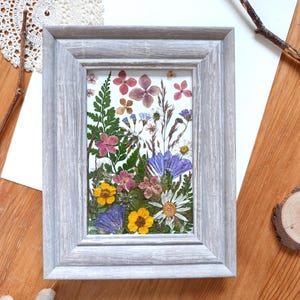 Framed picture with pressed natural flowers and leaves