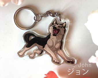 May include: A clear acrylic keychain featuring a cartoon dog with black and tan fur, open mouth, and a silver keyring. The dog's name, "John", is written in Japanese and English.