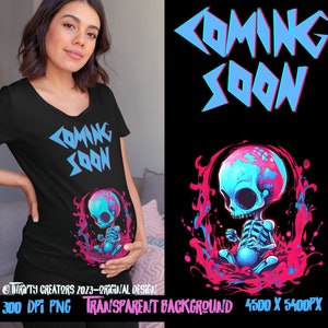 May include: A black t-shirt with a blue and pink graphic of a skull with a baby inside. The text "Coming Soon" is printed on the shirt in a blue and pink font.