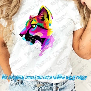 May include: A digital download of a colorful, abstract design of a cougar's head. The design is painted in shades of pink, blue, yellow, and green, with black accents. The design is perfect for use on t-shirts, mugs, tote bags, and other merchandise.