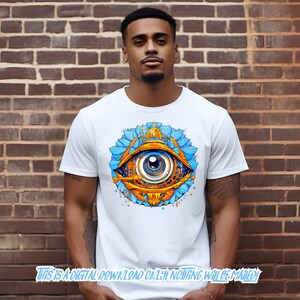 May include: A white t-shirt with a graphic of a blue and gold eye with intricate details. The eye is surrounded by a blue and gold floral design.