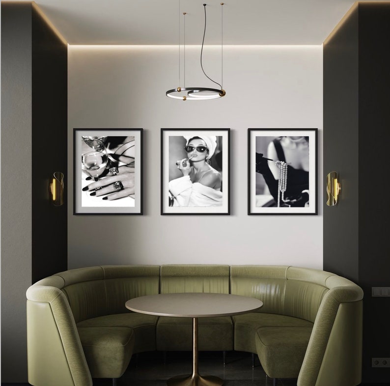 May include: Three black framed photographs of a woman in a black and white setting. The woman in the left photo is holding a glass of wine and wearing a ring. The woman in the center photo is wearing sunglasses and a white towel. The woman in the right photo is wearing a black dress and a pearl necklace.
