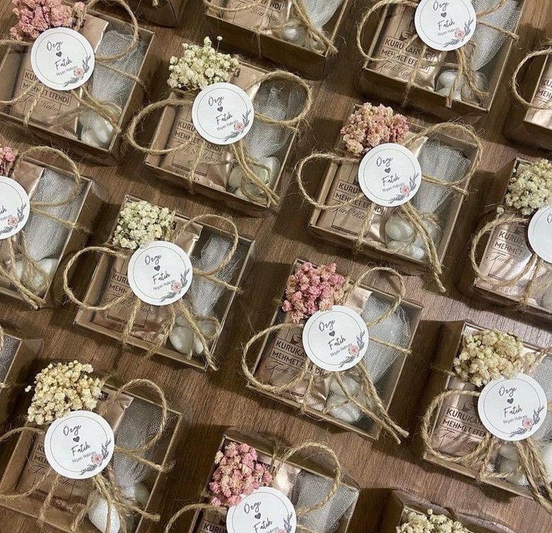 box decorated with flowers and label with Turkish coffee and a mini bottle of pebble chocolate is the perfect Affordable & Tasty Edible Wedding Favors idea.