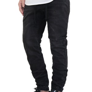 May include: Black jogger pants with a drawstring waist and cuffed ankles. The pants are made of a soft, comfortable fabric and have a relaxed fit.