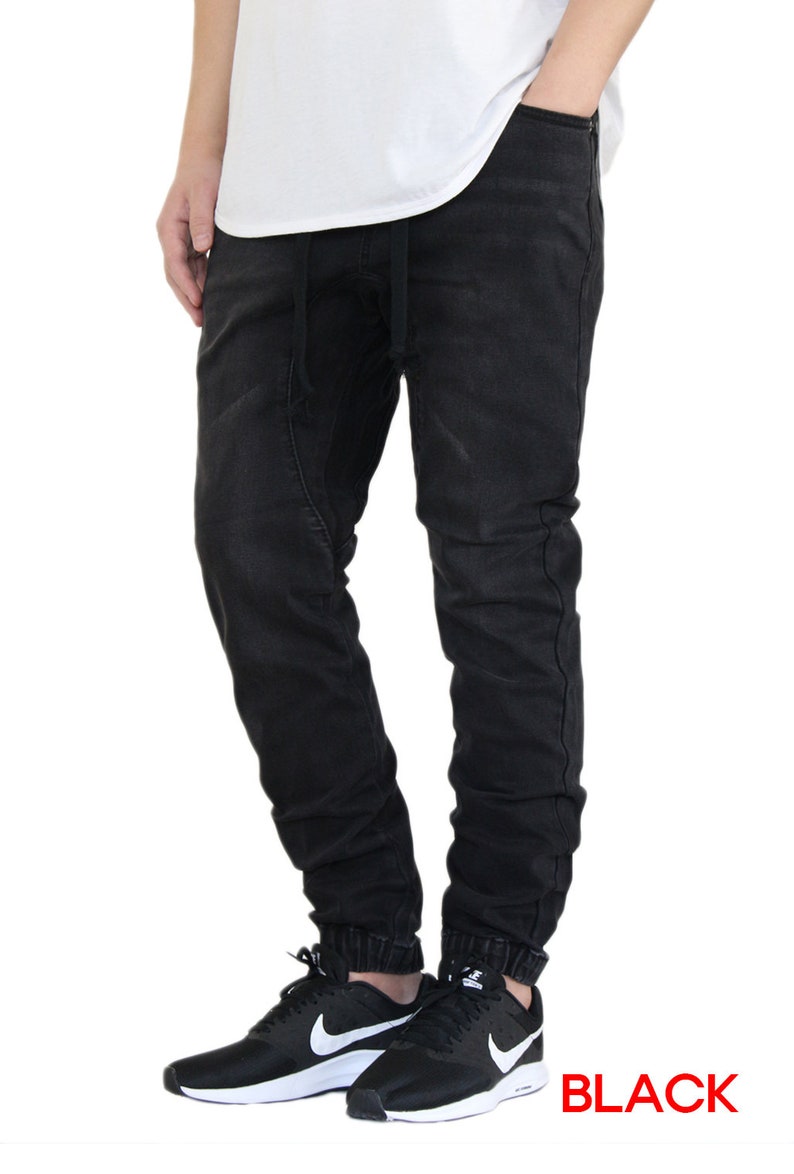 May include: Black jogger pants with a drawstring waist and cuffed ankles. The pants are made of a soft, comfortable fabric and have a relaxed fit.
