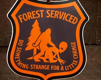Forest Serviced “Do something strange for a little change” charcoal and orange vinyl sticker