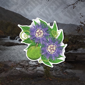 May include: A sticker featuring a detailed illustration of passion flowers. The design showcases two vibrant purple flowers with intricate details, green leaves, and a green passion fruit. The background is a scenic view of a river and mountains.