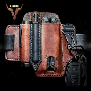 May include: A brown leather belt holster with a multi-tool, a pen, and a key chain with a car key and a small knife. The holster has a black strap and stitching.