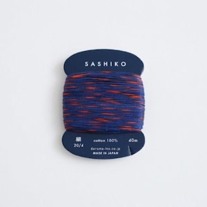 May include: A spool of blue and orange sashiko thread with the text "SASHIKO" printed on the label. The label also includes the text "cotton 100%", "20/4", "40m", "daruma-ito.co.jp", and "MADE IN JAPAN".