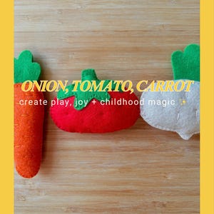 May include: Three felt food toys: an orange carrot, a red tomato, and a white onion. Each has a green felt top. Text on the image reads "ONION, TOMATO, CARROT - create play, joy + childhood magic".