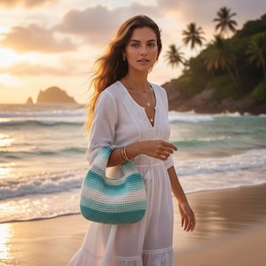 May include: A woman wearing a white dress and carrying a blue, white, and teal crochet handbag on a beach. The handbag has a rounded shape and a striped pattern. The background features a sunset over the ocean and palm trees.