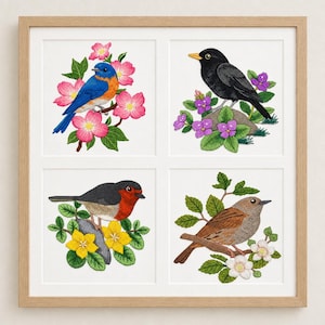May include: A square wooden frame containing four separate embroidered panels. Each panel features a different bird: a bluebird with pink flowers, a black bird with purple flowers, a robin with yellow flowers, and a brown bird with white flowers.