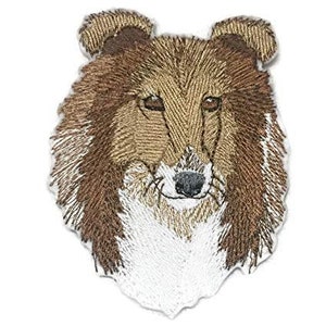 May include: Embroidered patch of a brown and white Collie dog's head. The dog has a long, fluffy coat and a friendly expression.