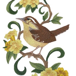 May include: Embroidered patch featuring a brown and yellow bird perched on a branch with yellow flowers. The bird is surrounded by green leaves and vines.