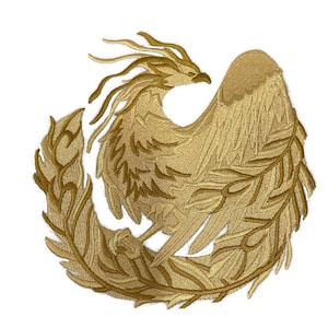 May include: Embroidered patch featuring a golden phoenix with outstretched wings, encircled by a laurel wreath. The phoenix has detailed feathering and a fierce expression. The patch is likely for apparel or accessories.