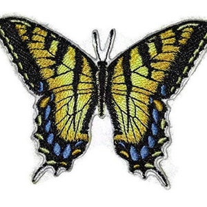 May include: A yellow and black butterfly with blue accents embroidered on a white background.
