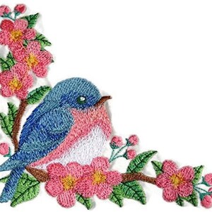 May include: Embroidered patch featuring a bluebird perched on a branch with pink blossoms. The bird has a pink breast and blue wings. The flowers are detailed with yellow centers.